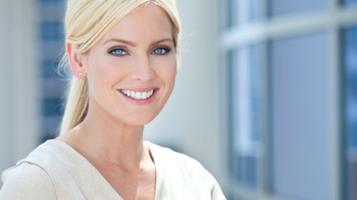 A happy patient in Augusta showing a confident smile after dental implant surgery